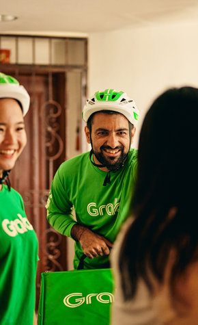 a group of people wearing green shirts and helmets