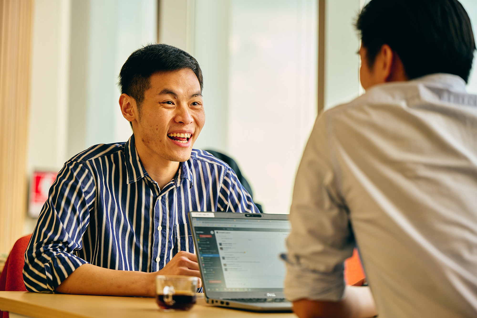 a man smiling at another man