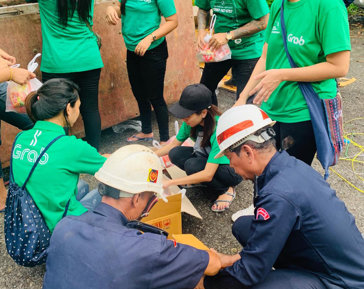 a group of people in green shirts