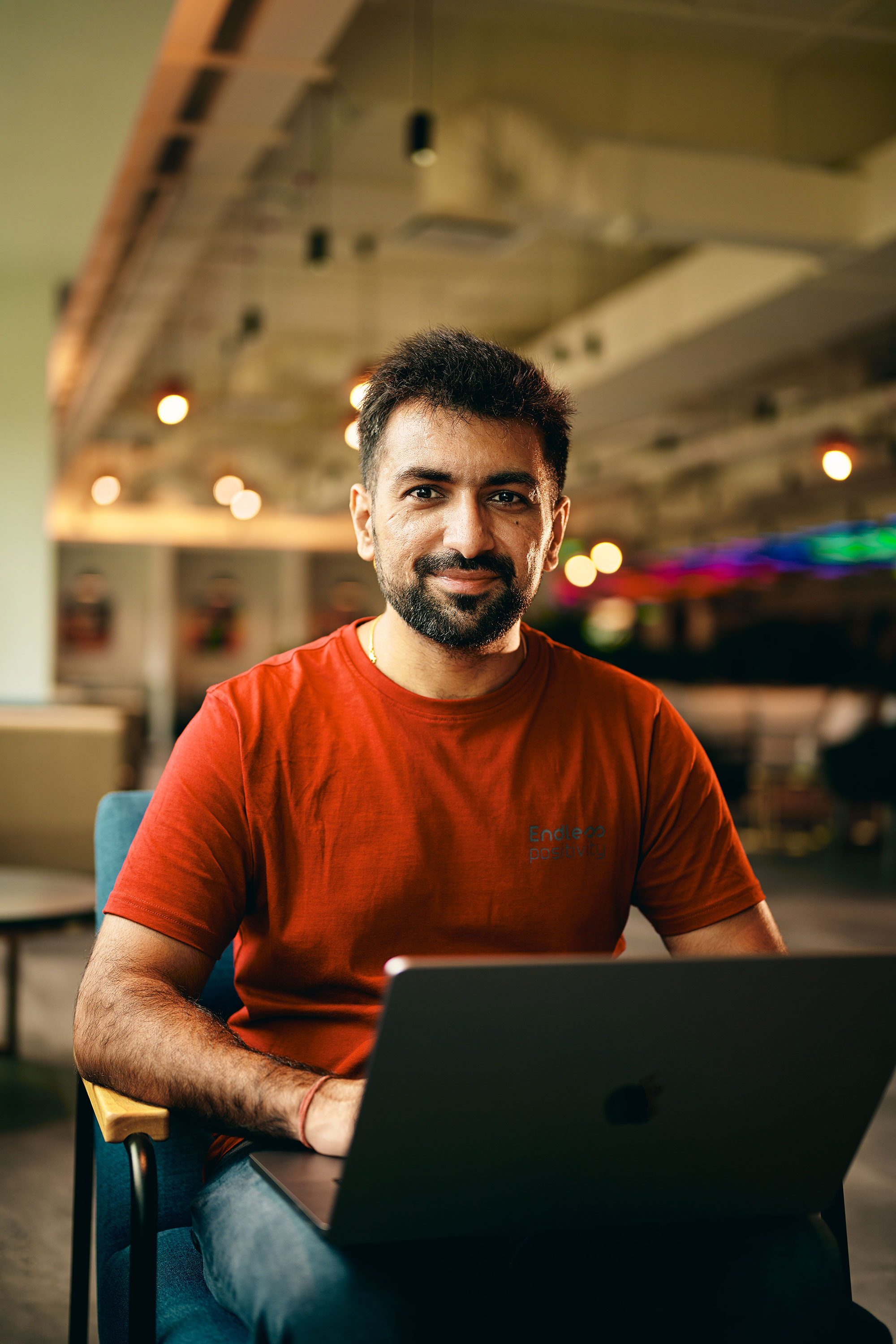 a man sitting in a chair with a laptop