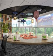 a room with a large round table and chairs