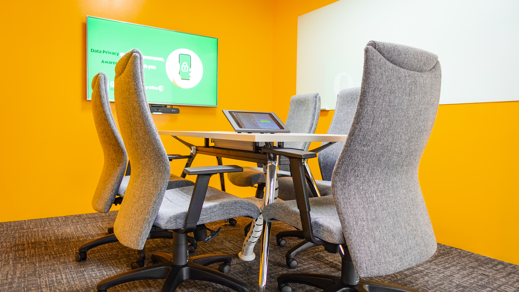 a table with chairs and a laptop