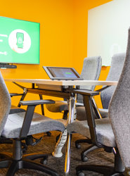 a table with chairs and a laptop