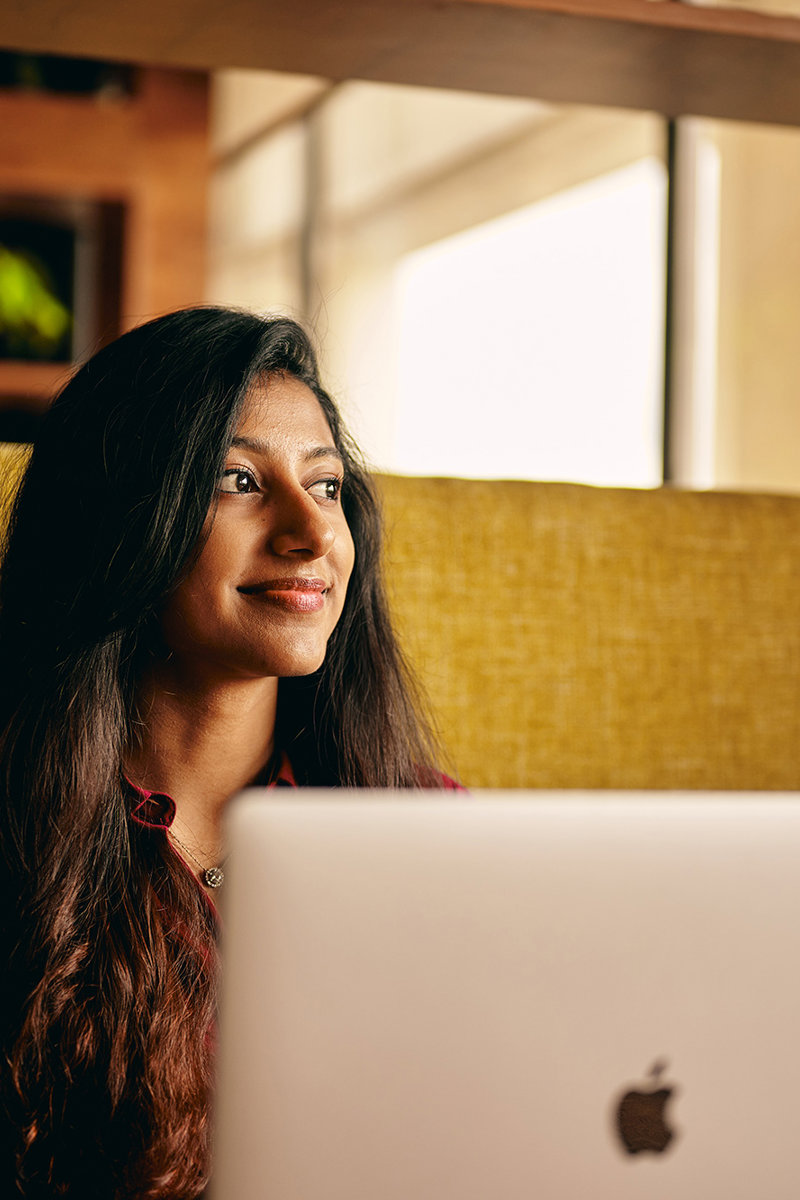 a woman looking away from a laptop