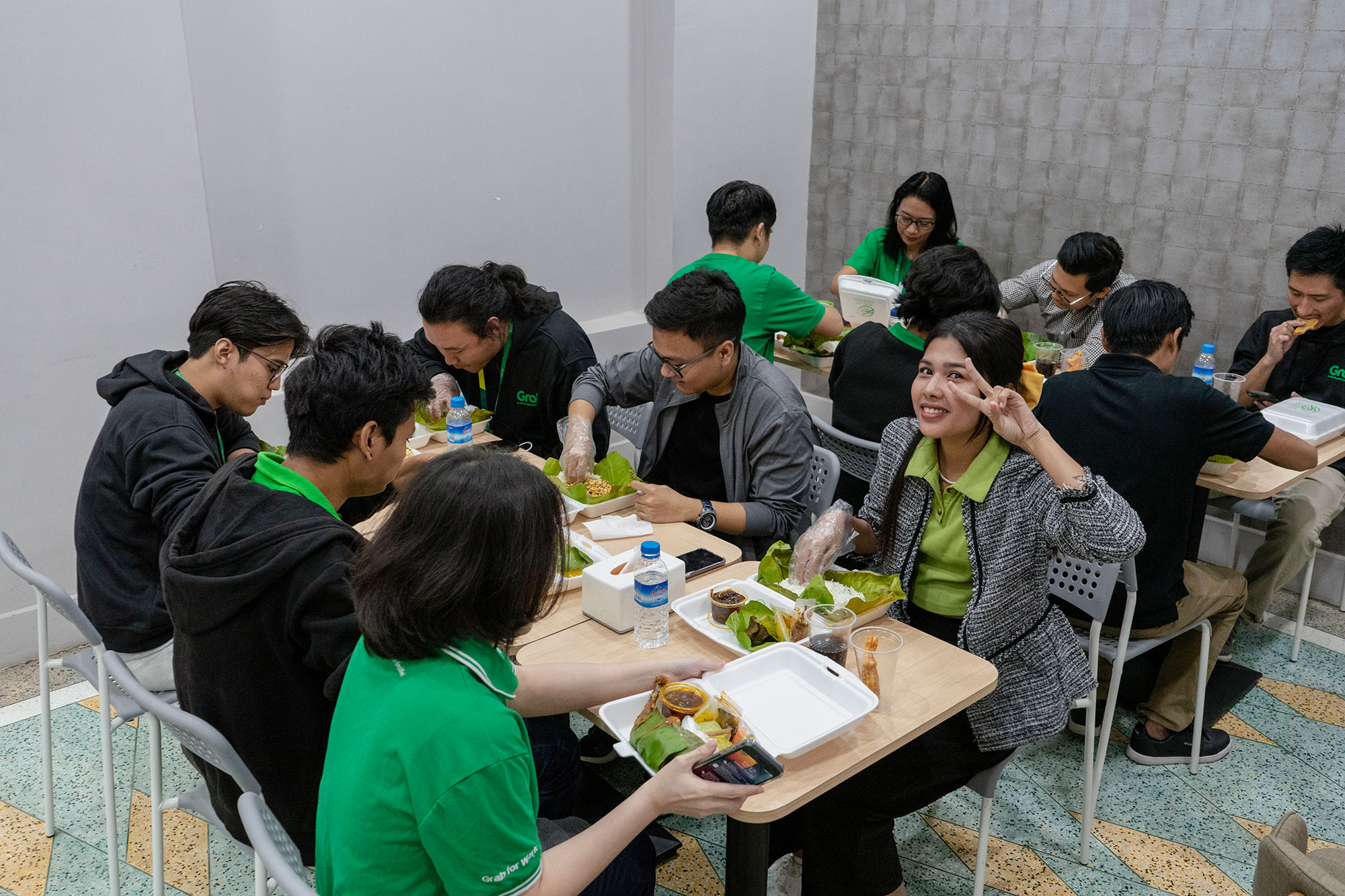 a group of people sitting at a table eating