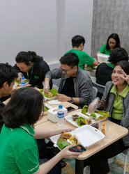 a group of people sitting at a table eating