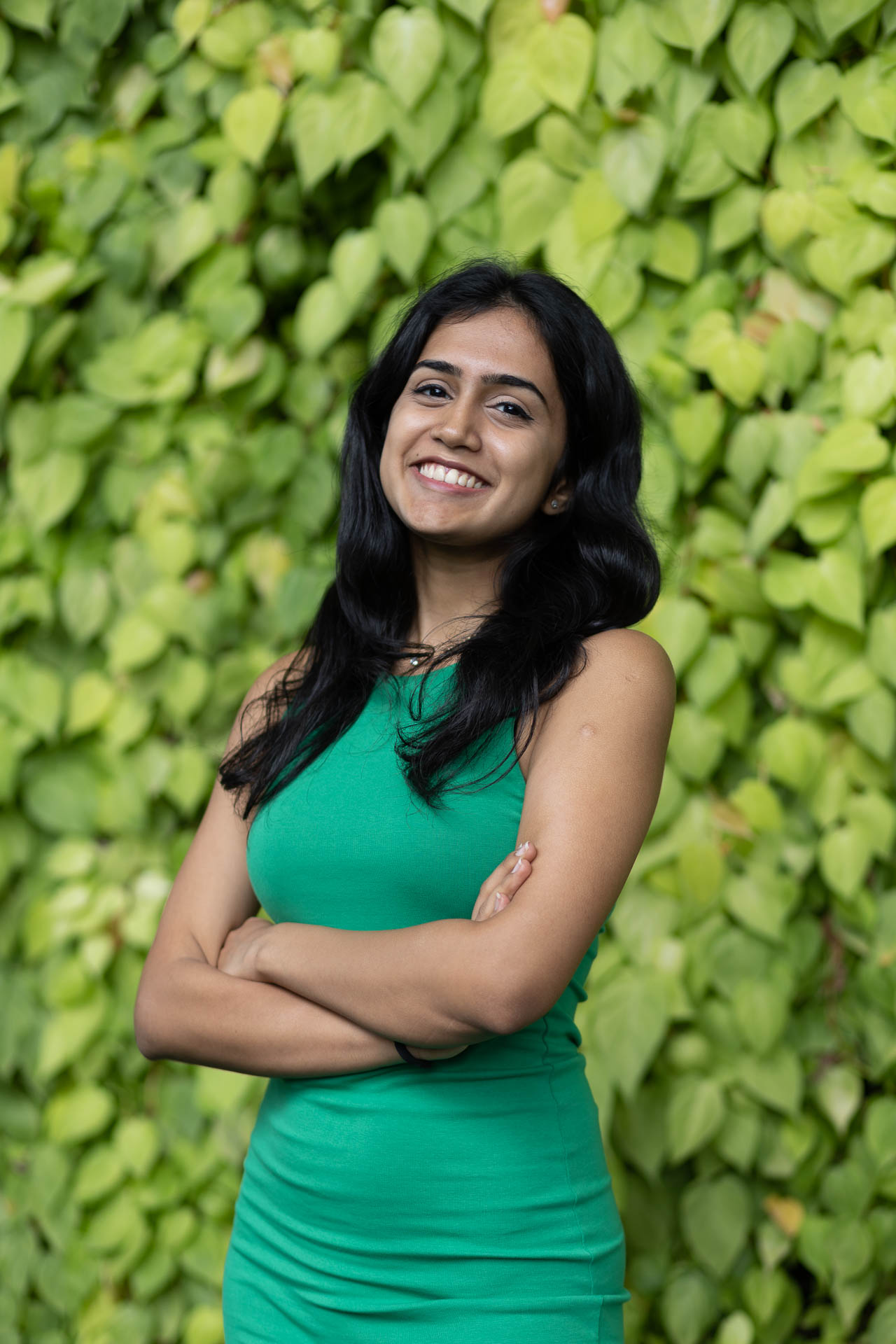 a person smiling with arms crossed
