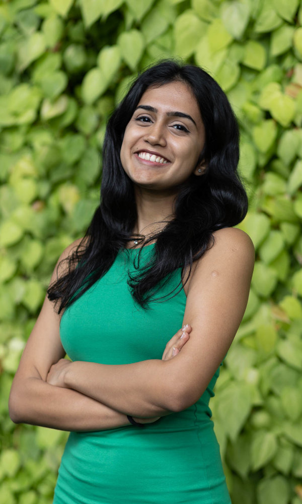 a person smiling with arms crossed