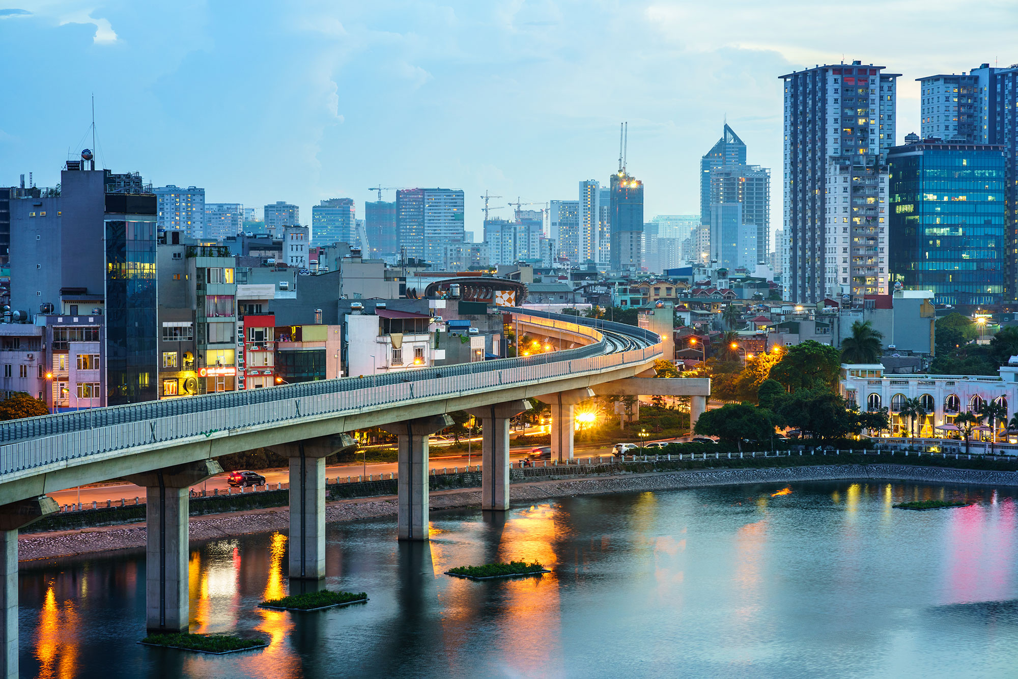 a bridge over a body of water with buildings in the background
