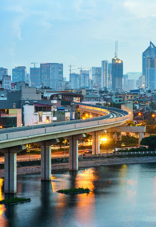 a bridge over a body of water with buildings in the background