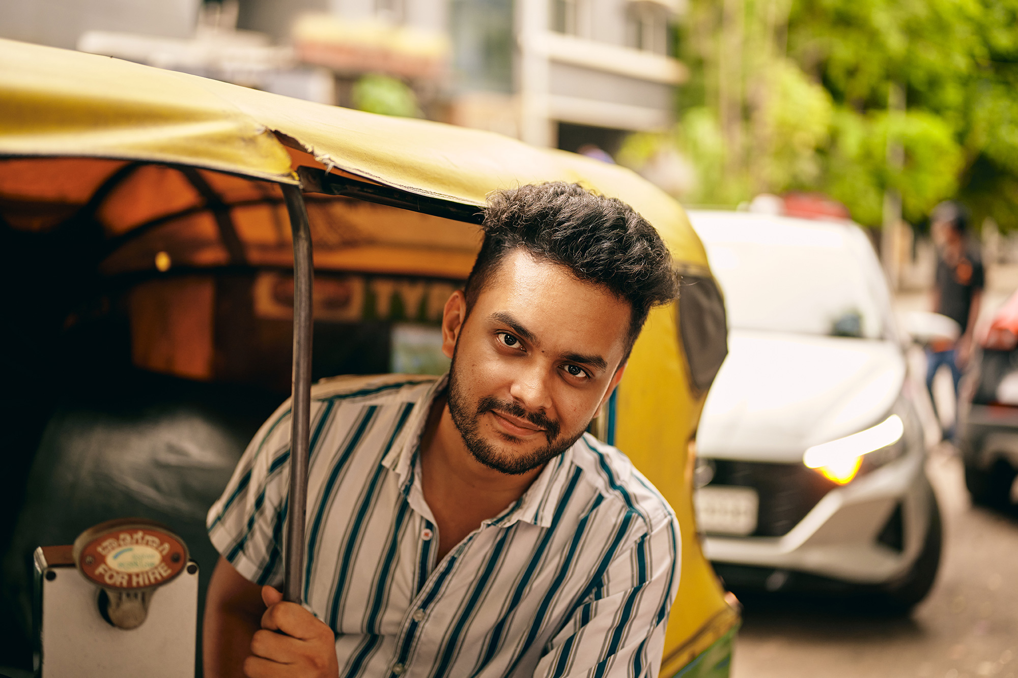 a man sitting in a yellow and green vehicle