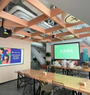 a room with tables and chairs and a projector screen