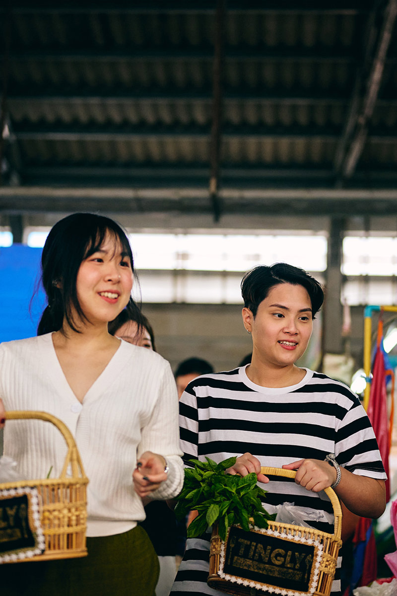 a couple of women holding baskets in a market
