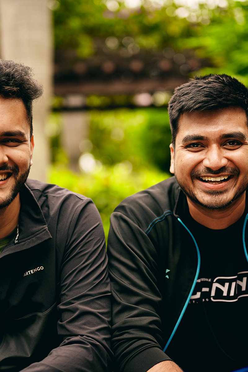 two men smiling at the camera