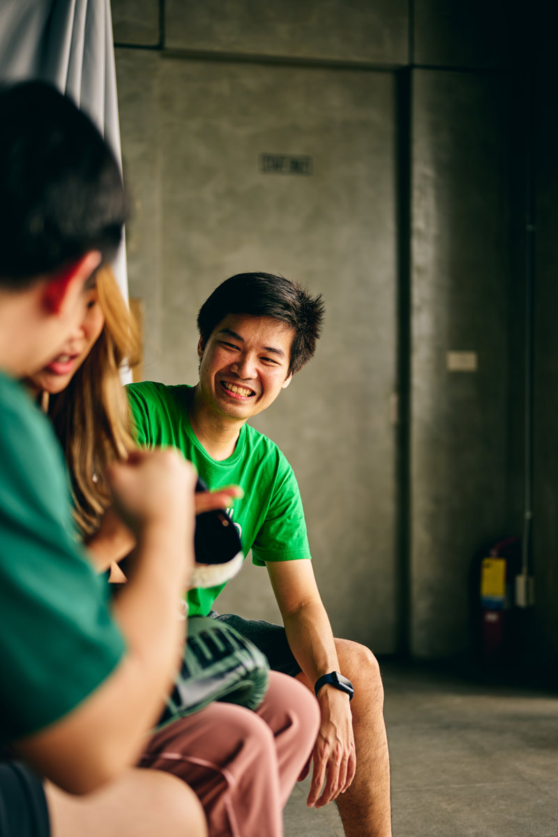 a person in a green shirt laughing