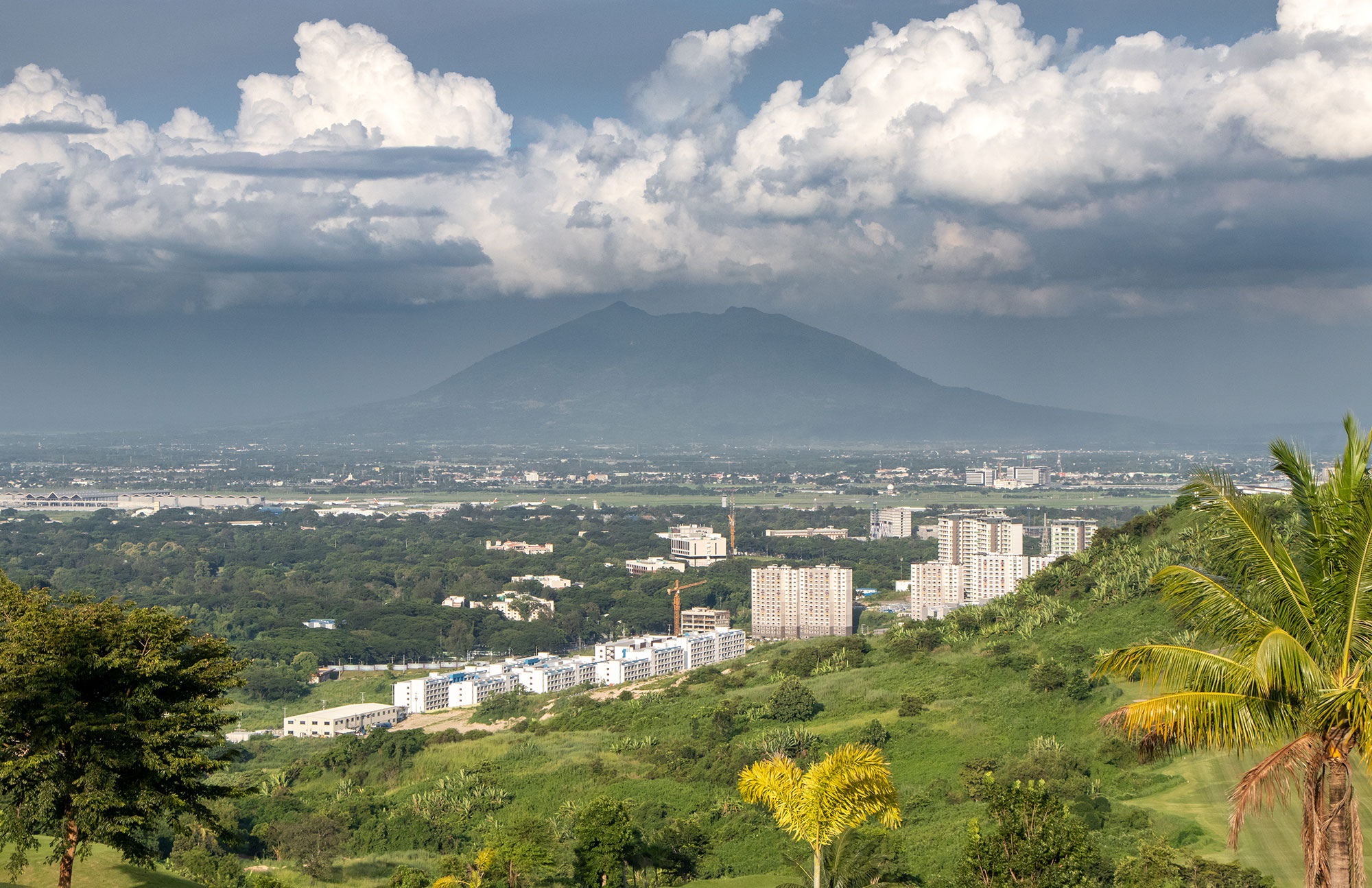a landscape with a mountain in the background