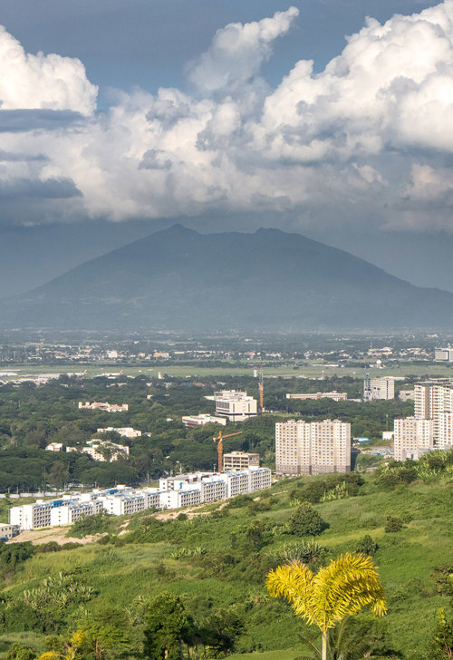 a landscape with a mountain in the background