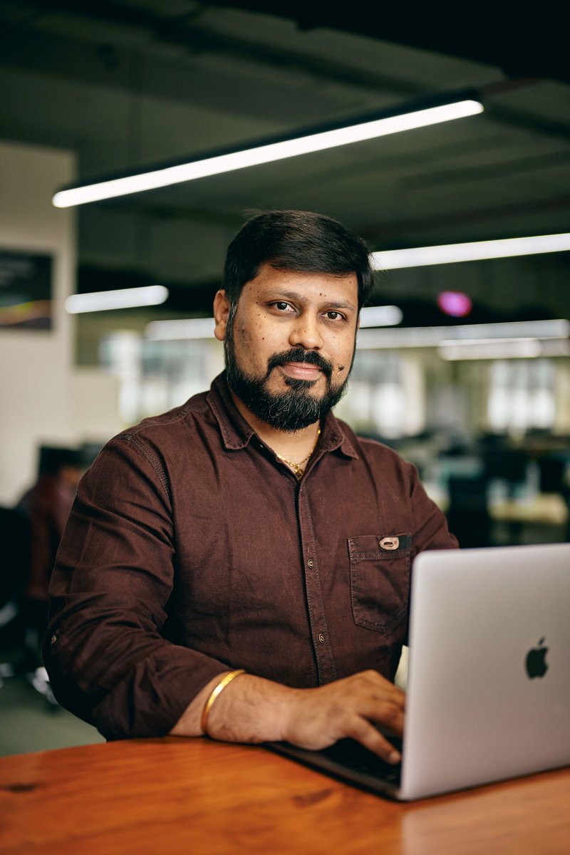 a man sitting at a desk with a laptop