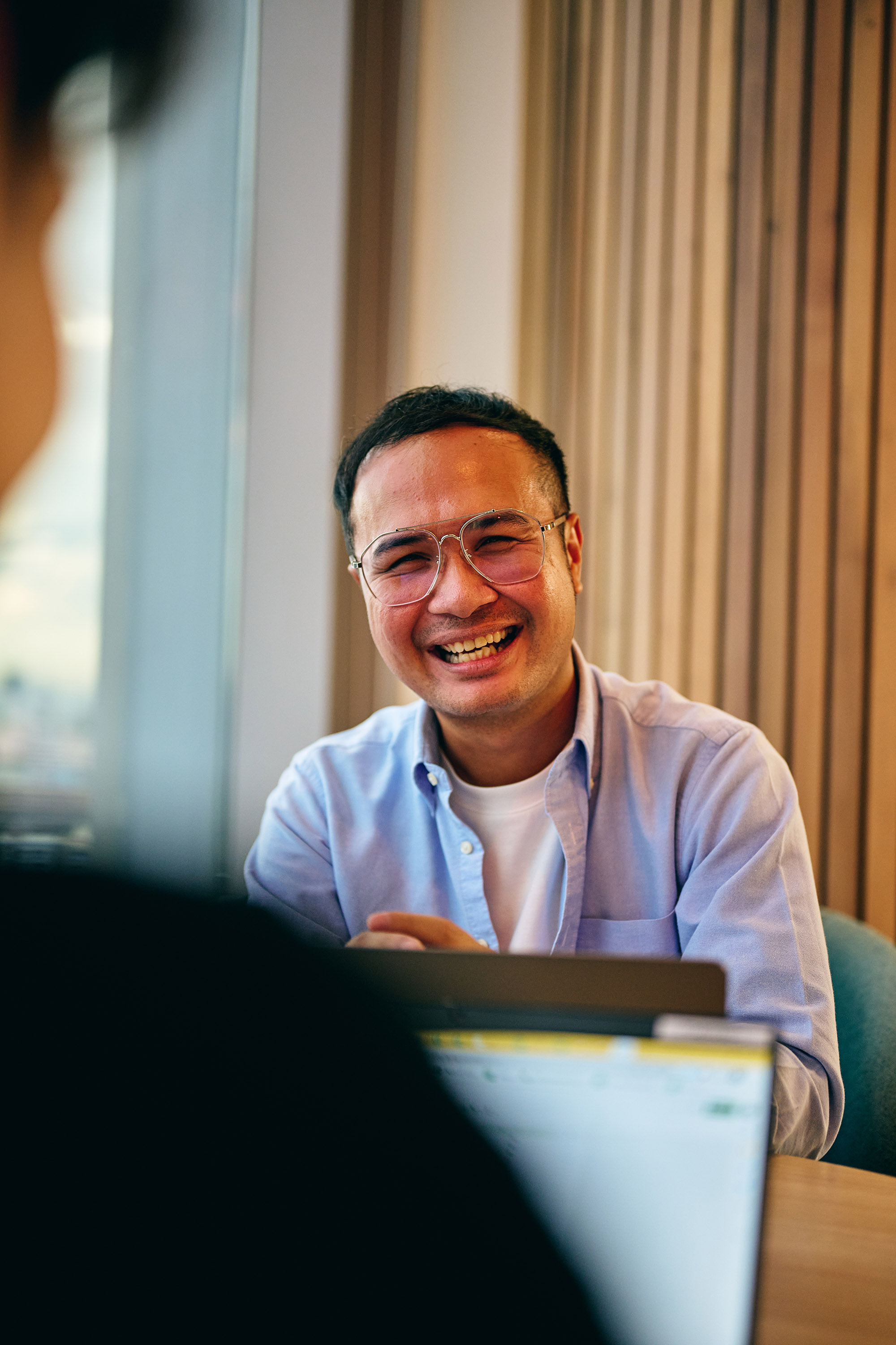a man in glasses laughing