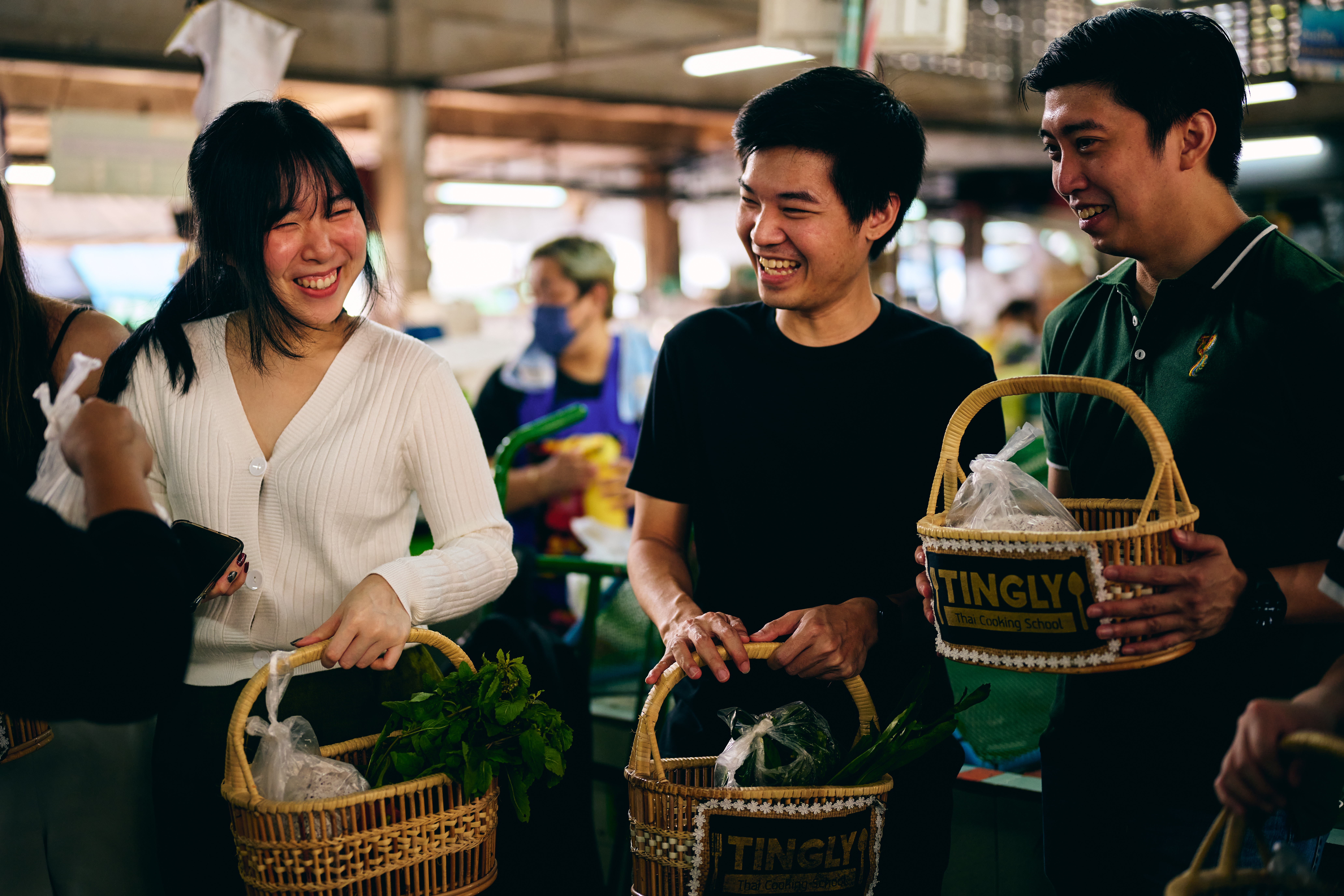 a group of people holding baskets