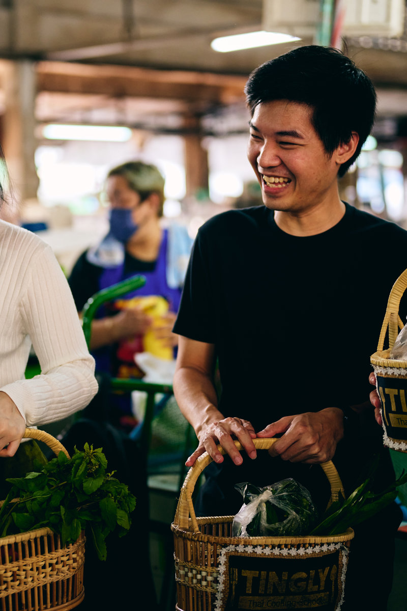 a group of people holding baskets
