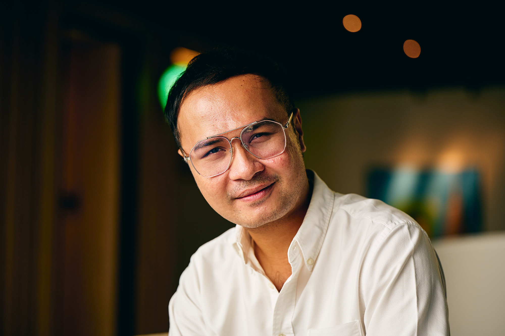 a man wearing glasses and a white shirt