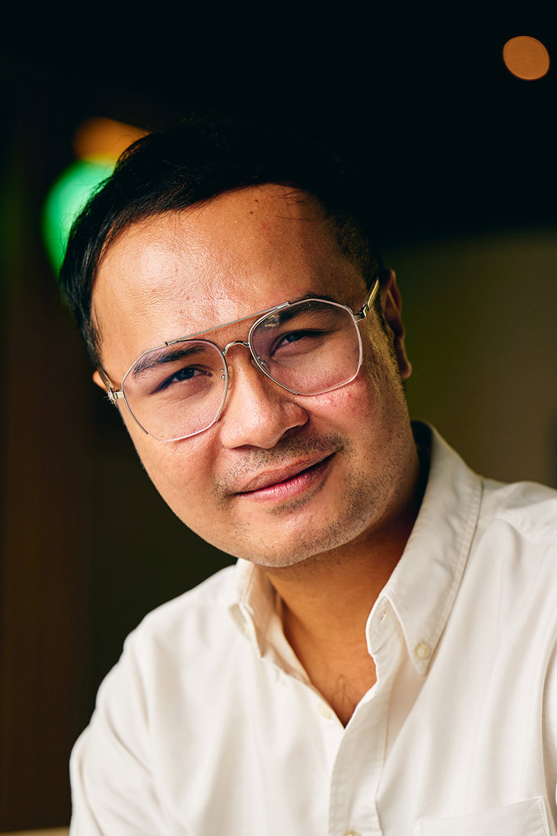 a man wearing glasses and a white shirt