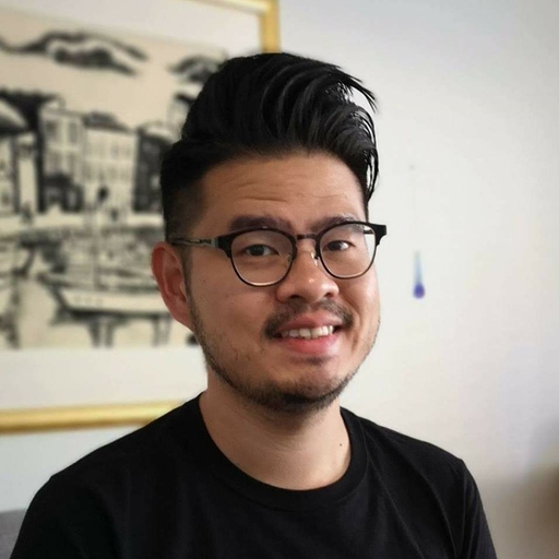 a person wearing glasses and smiling