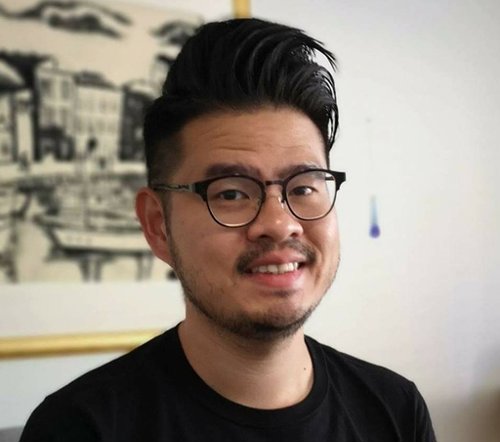 a person wearing glasses and smiling