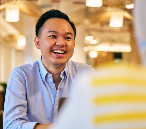 a man smiling at another man