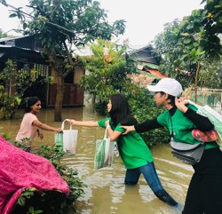 a group of people carrying shopping bags in a flooded area