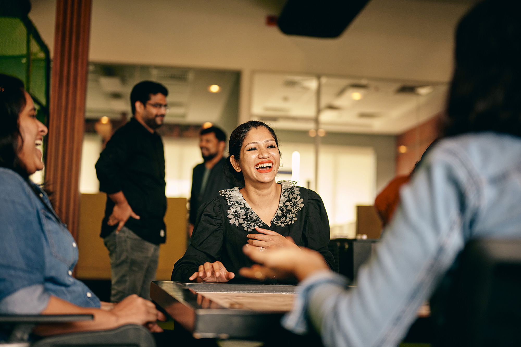 a woman laughing at a table