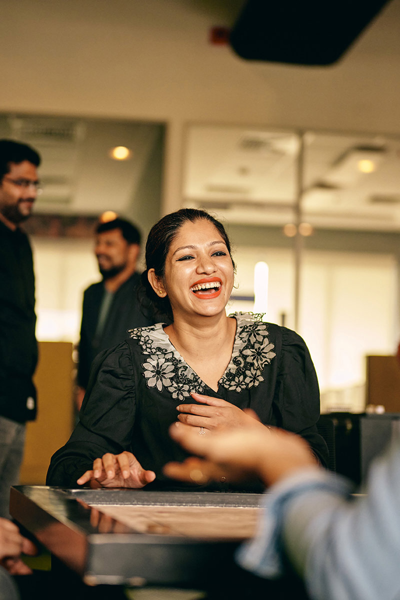 a woman laughing at a table