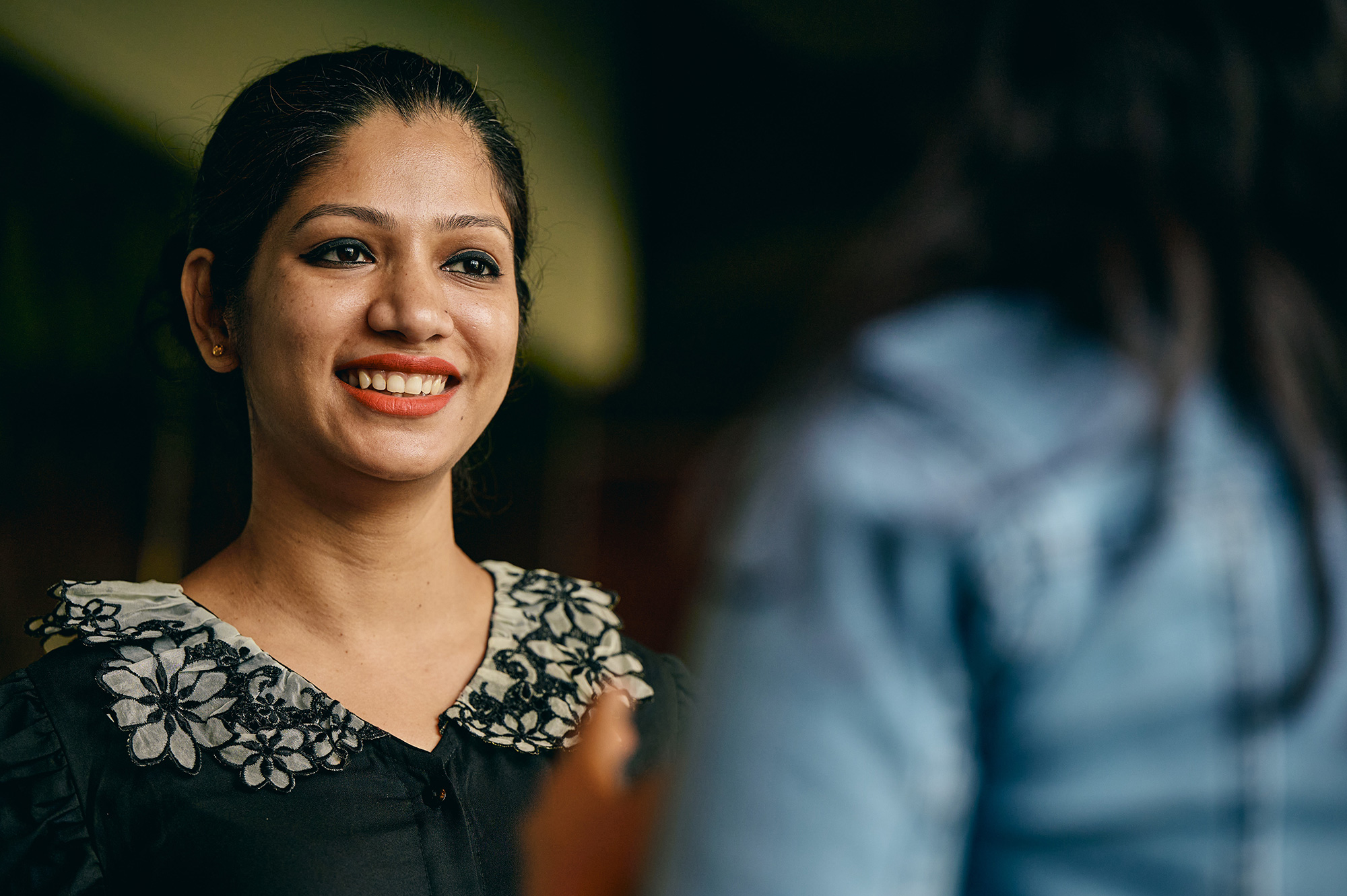 a woman smiling at another woman