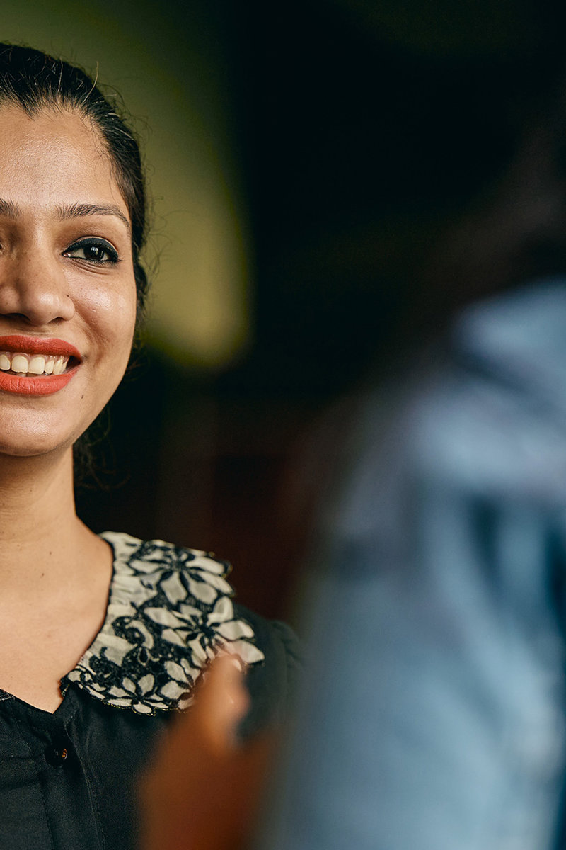a woman smiling at another woman