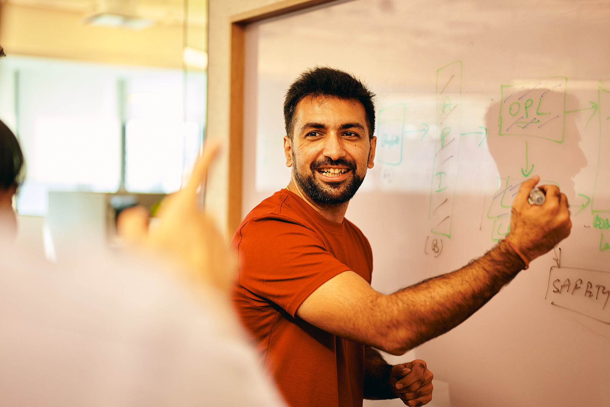a man writing on a whiteboard