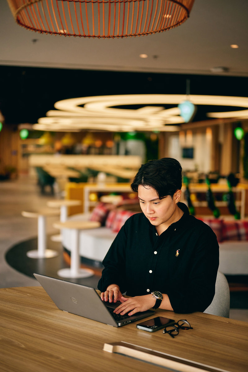 a man sitting at a table using a laptop