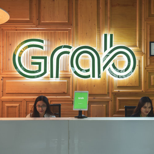 a group of women sitting at a desk