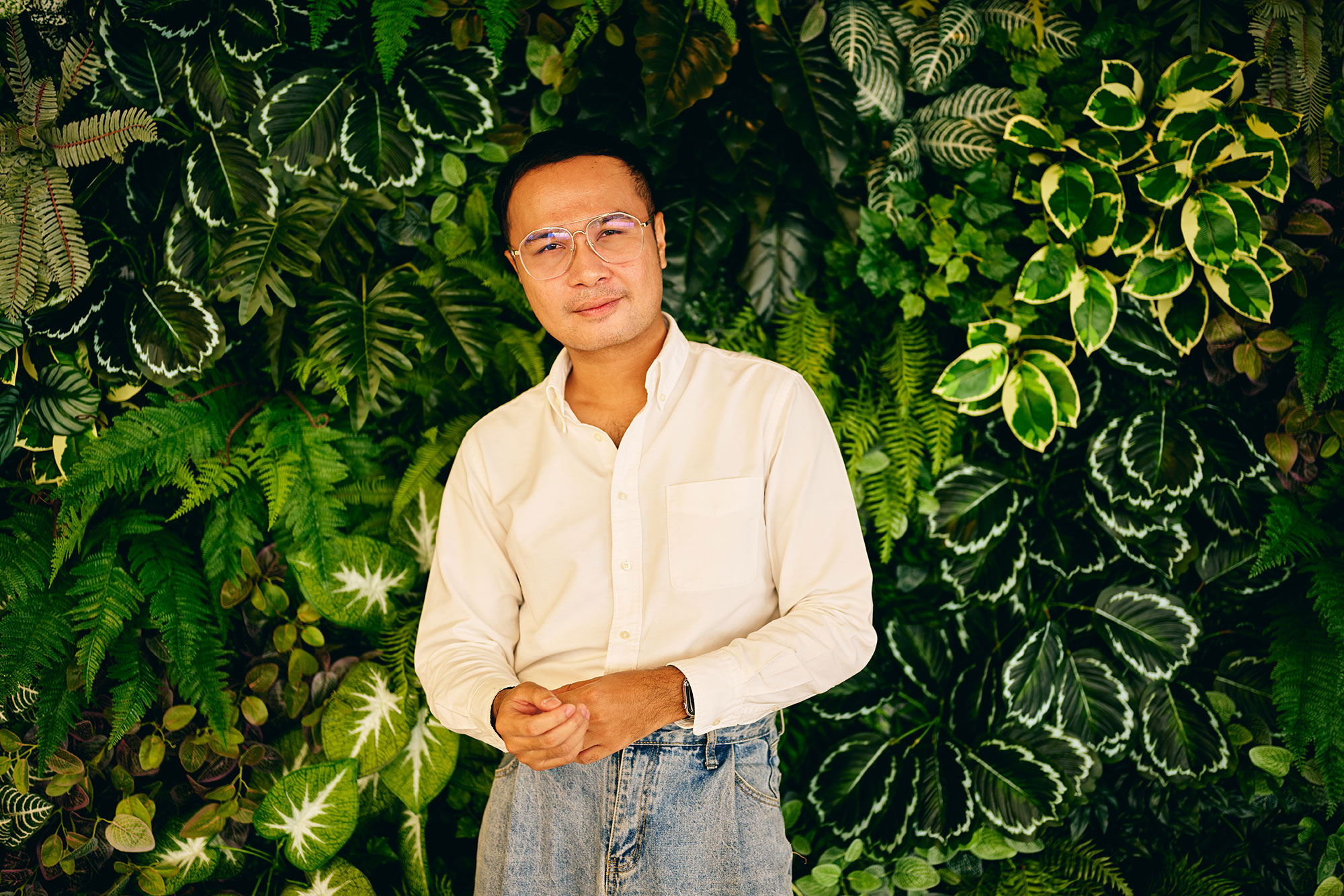 a man standing in front of a green wall