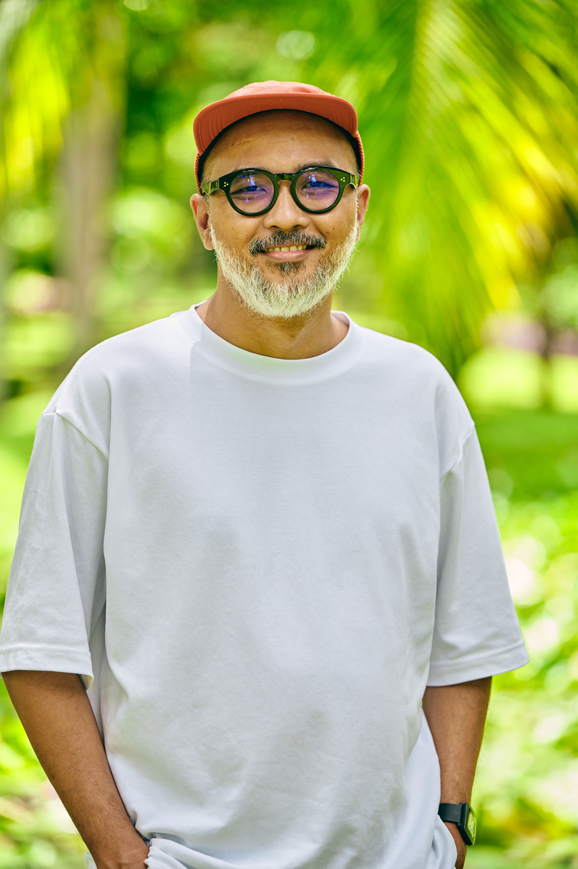 a man wearing a white shirt and red hat