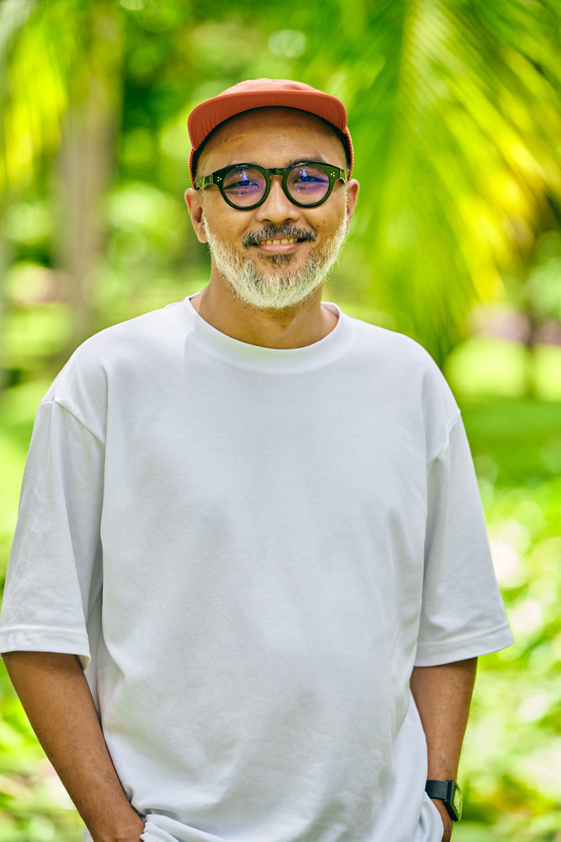 a man wearing a white shirt and red hat
