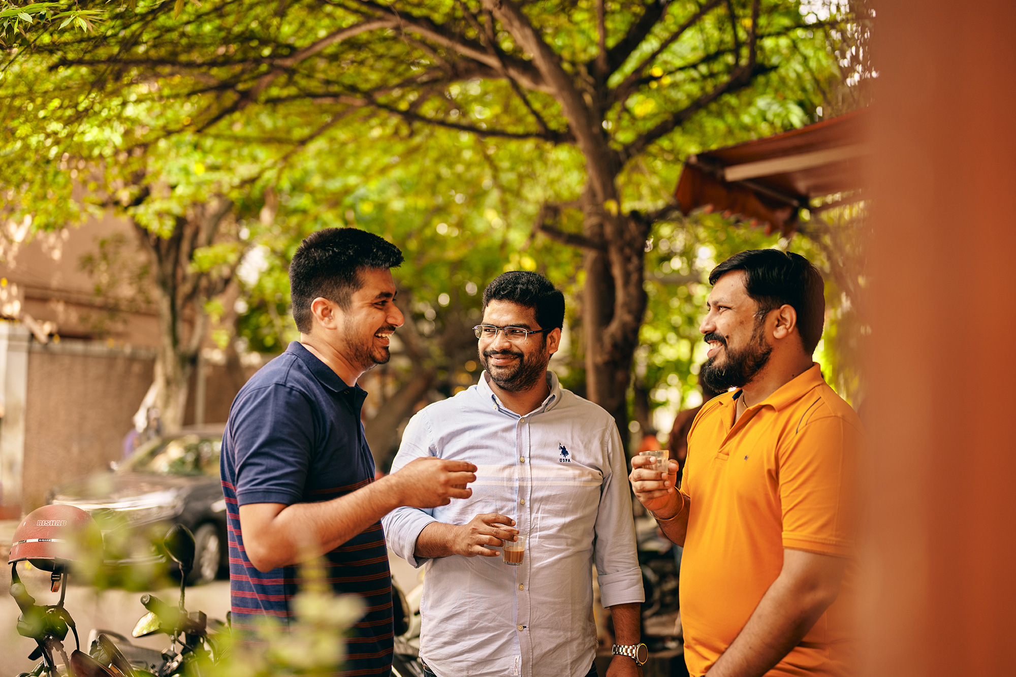 a group of men standing outside and talking