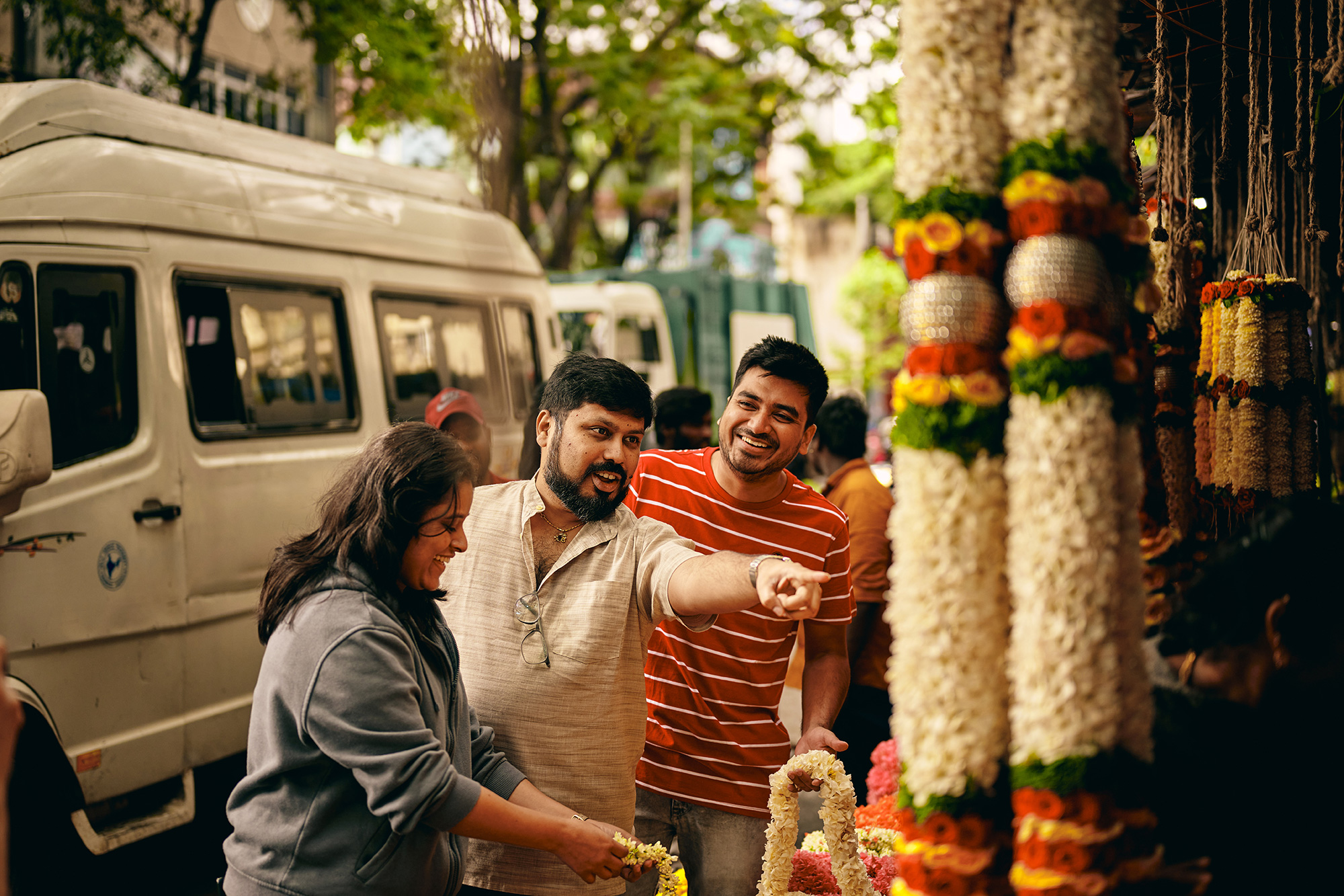 a group of people standing next to a flower display