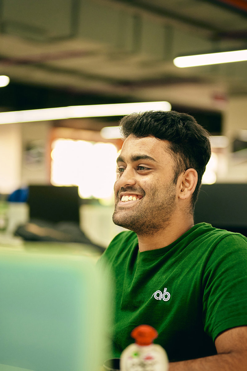 a man in a green shirt smiling