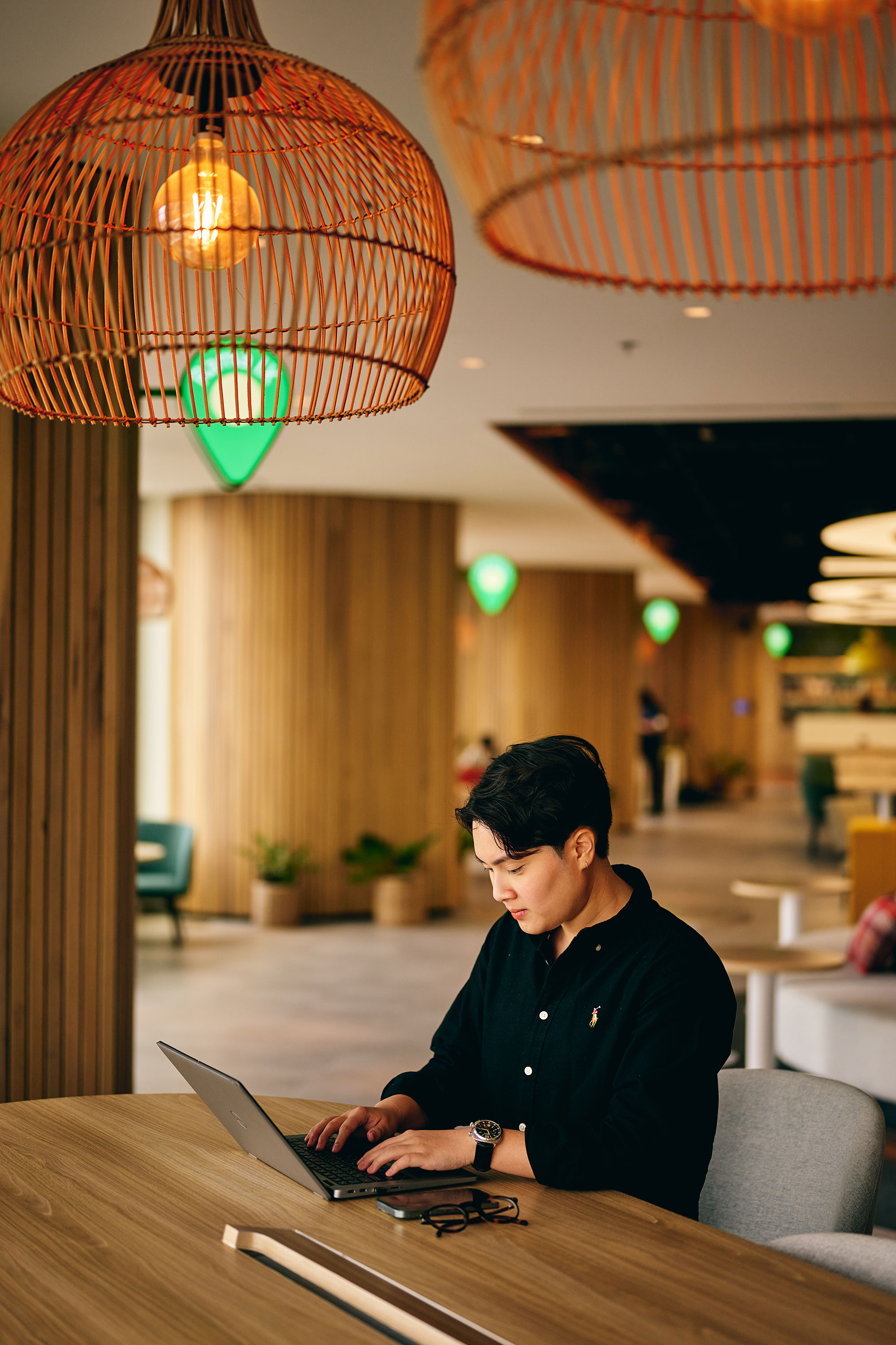 a woman sitting at a table using a laptop