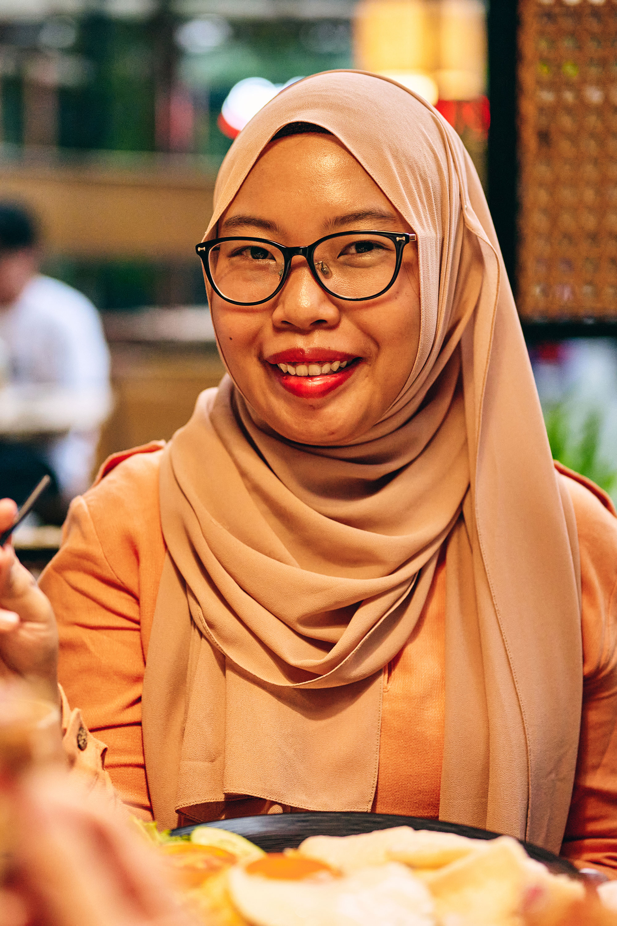 a woman wearing glasses and a scarf
