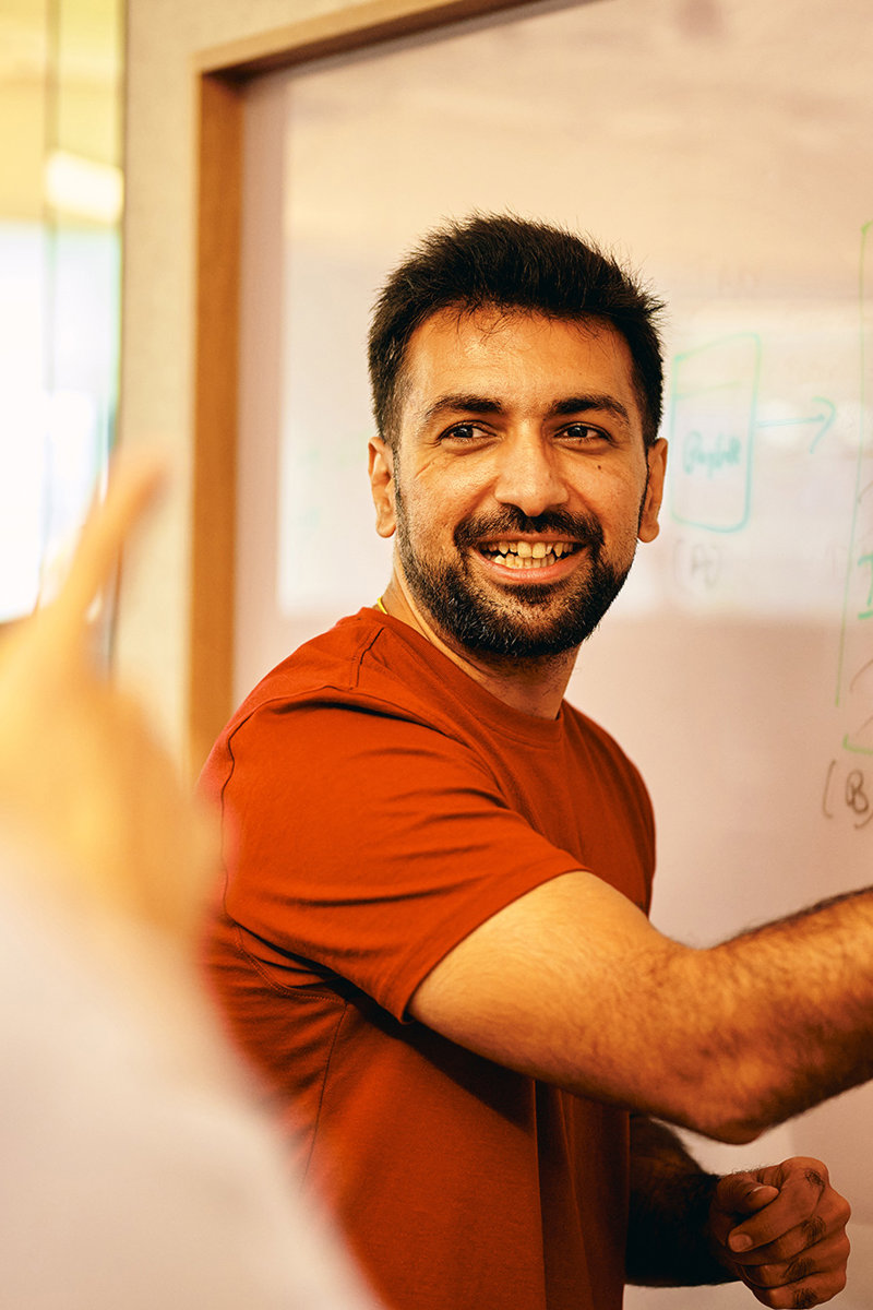 a man writing on a whiteboard
