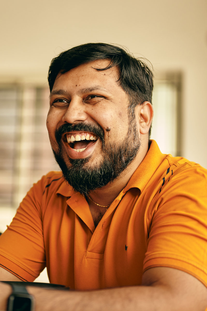 a person laughing with a beard