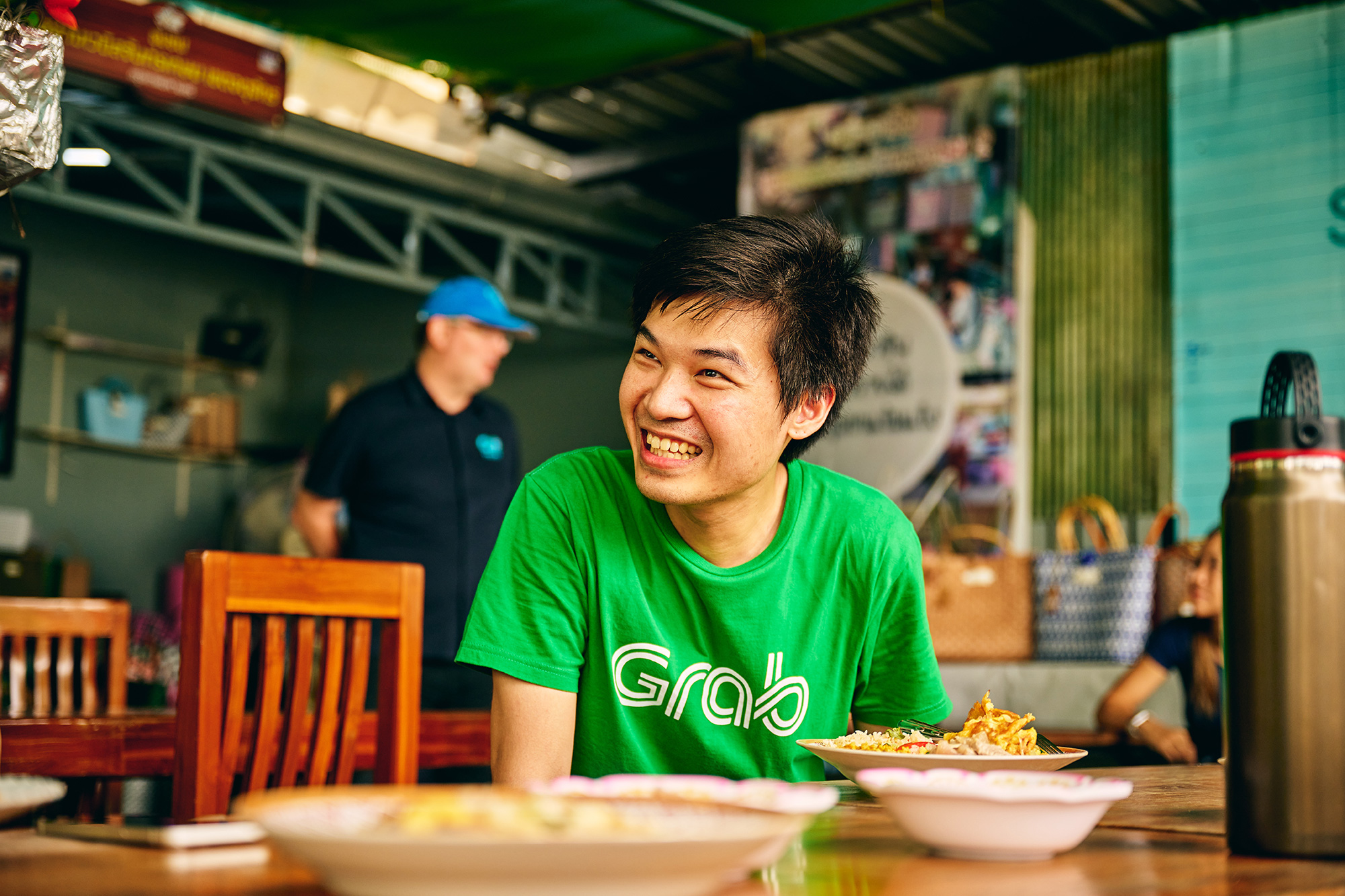 a man smiling at a plate of food