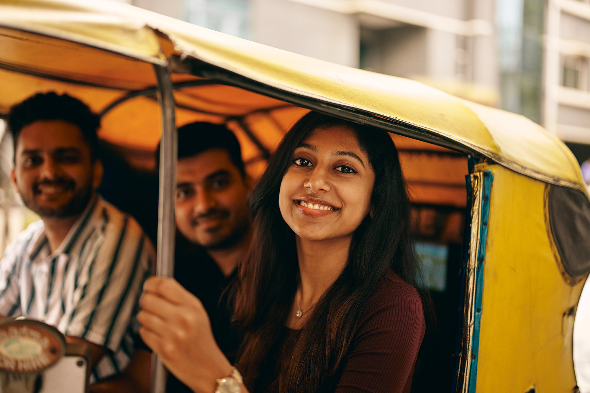 a woman smiling in a yellow vehicle